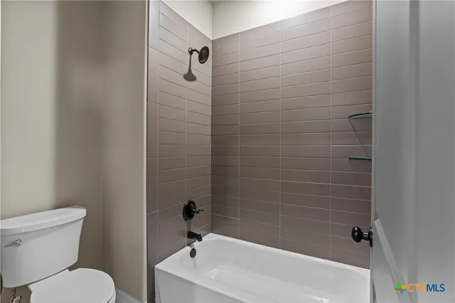 a bathroom with a toilet and shower