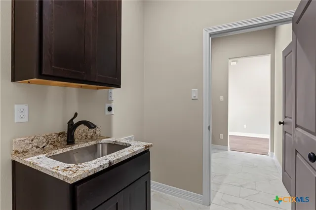 a kitchen with a sink and cabinets