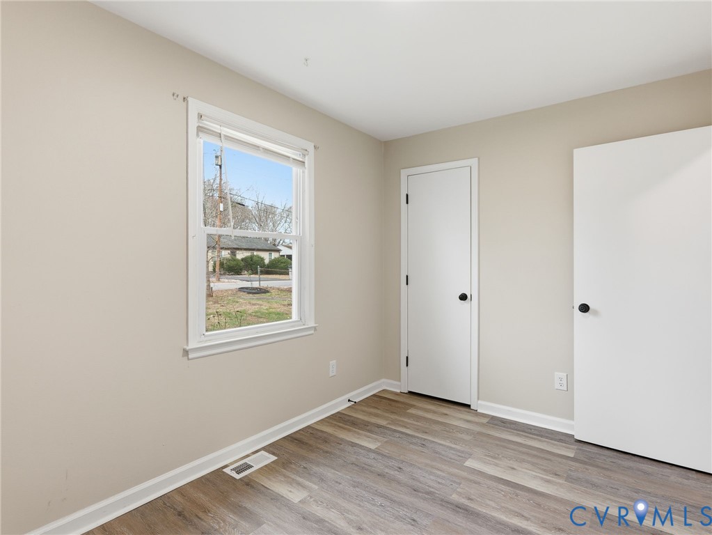 3626 Gilbert Street Hopewell, VA 23860 - Photo 11 of 20 a view of an empty room with wooden floor and a window