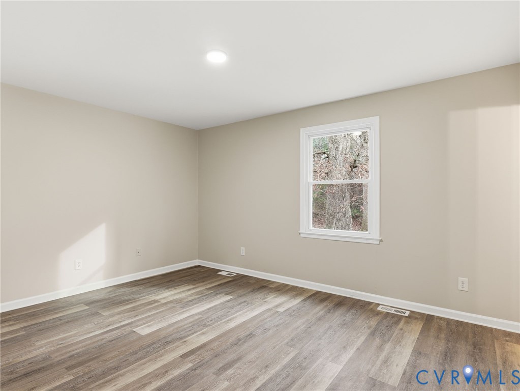 3626 Gilbert Street Hopewell, VA 23860 - Photo 13 of 20 wooden floor in an empty room with a window