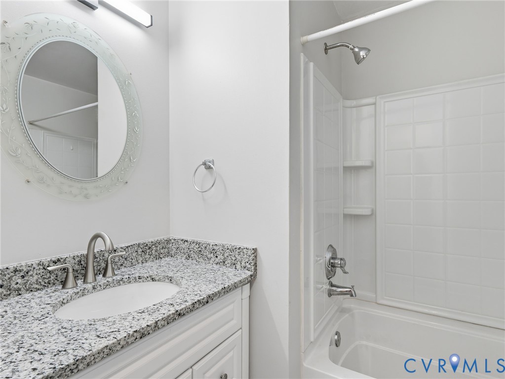 3626 Gilbert Street Hopewell, VA 23860 - Photo 8 of 20 a bathroom with a granite countertop sink and a mirror