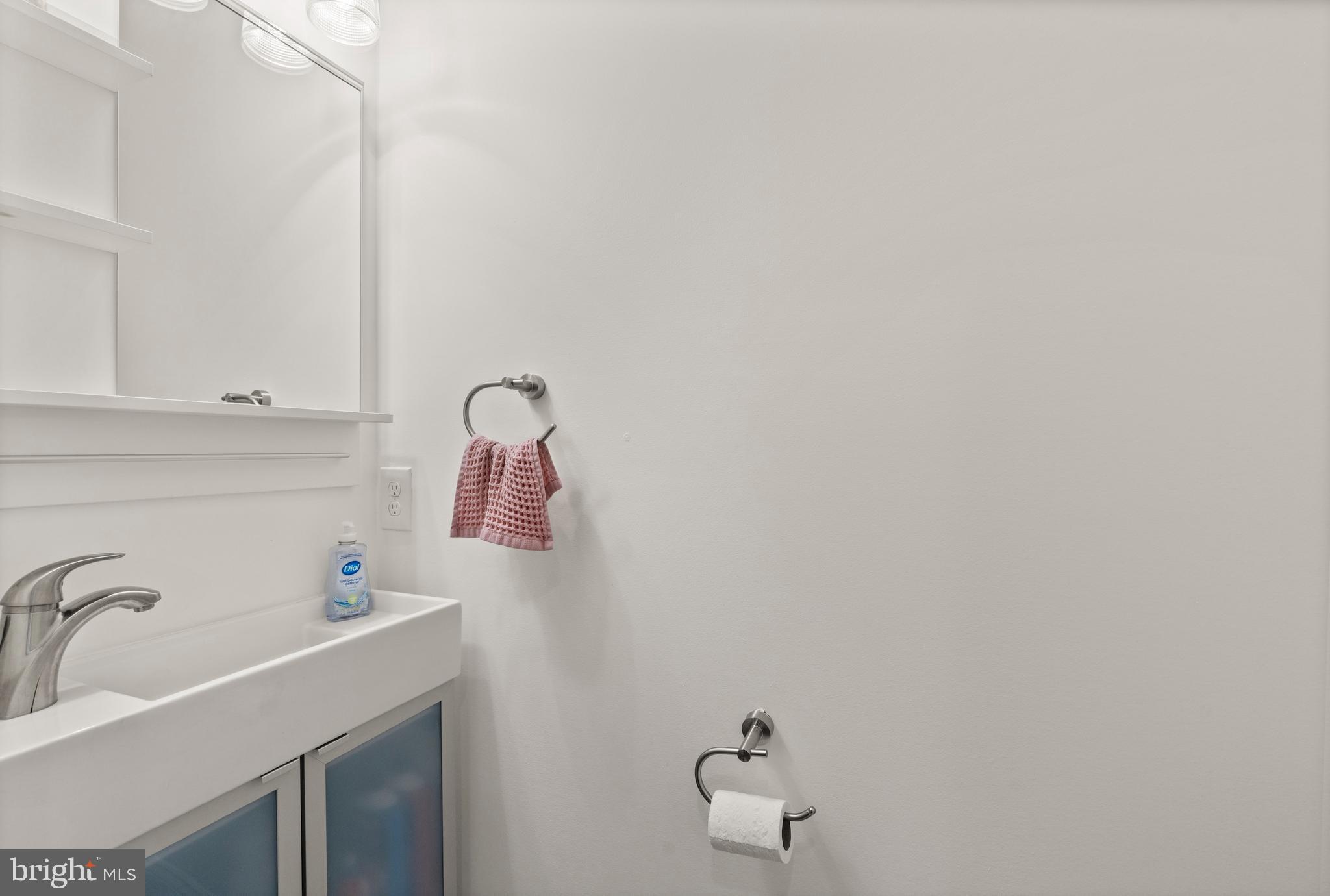 431 South Robinson Street Baltimore, MD 21224 - Photo 16 of 29 a bathroom with a sink and mirror