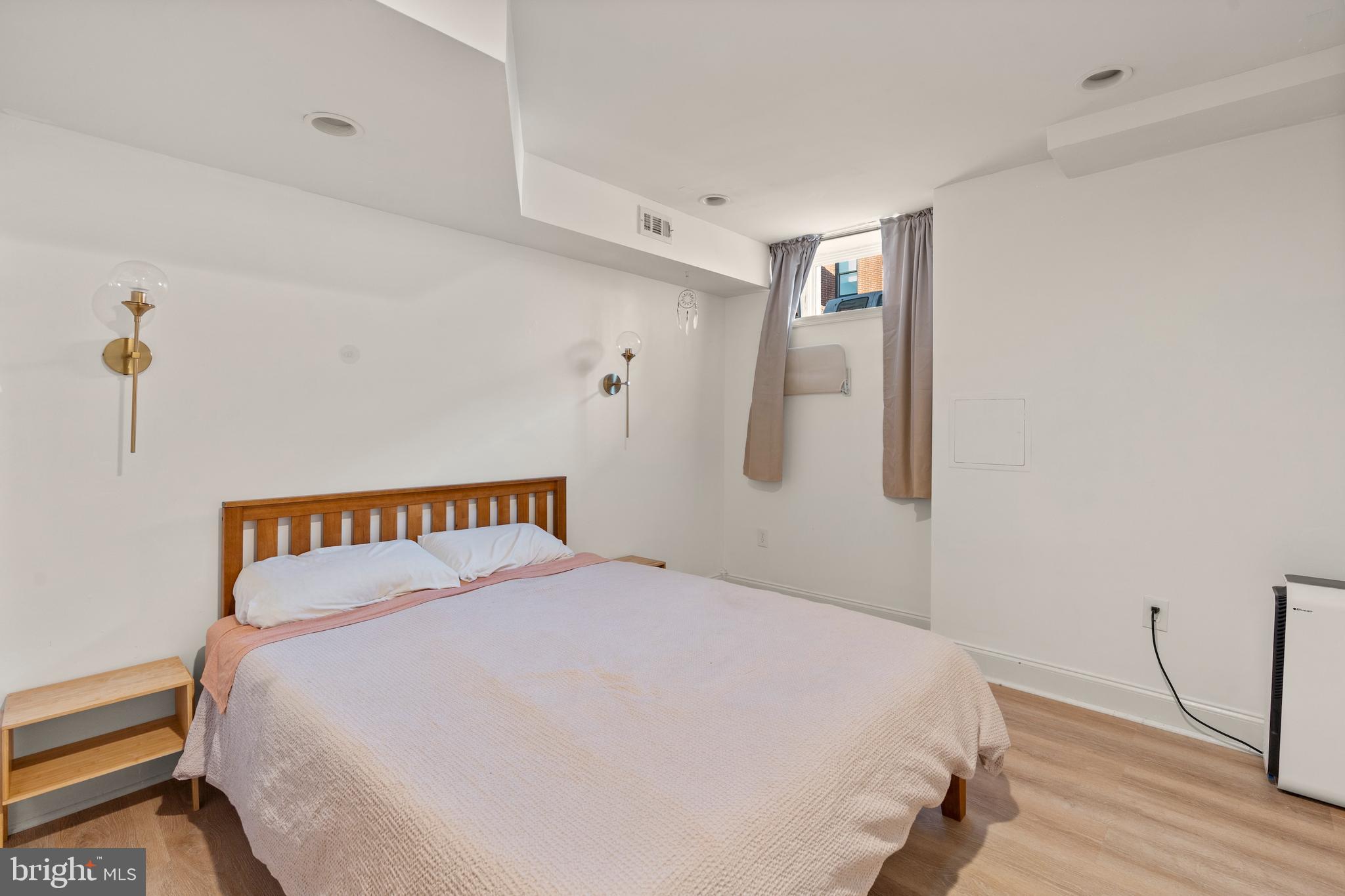 431 South Robinson Street Baltimore, MD 21224 - Photo 17 of 29 a bed sitting in a bedroom next to a window