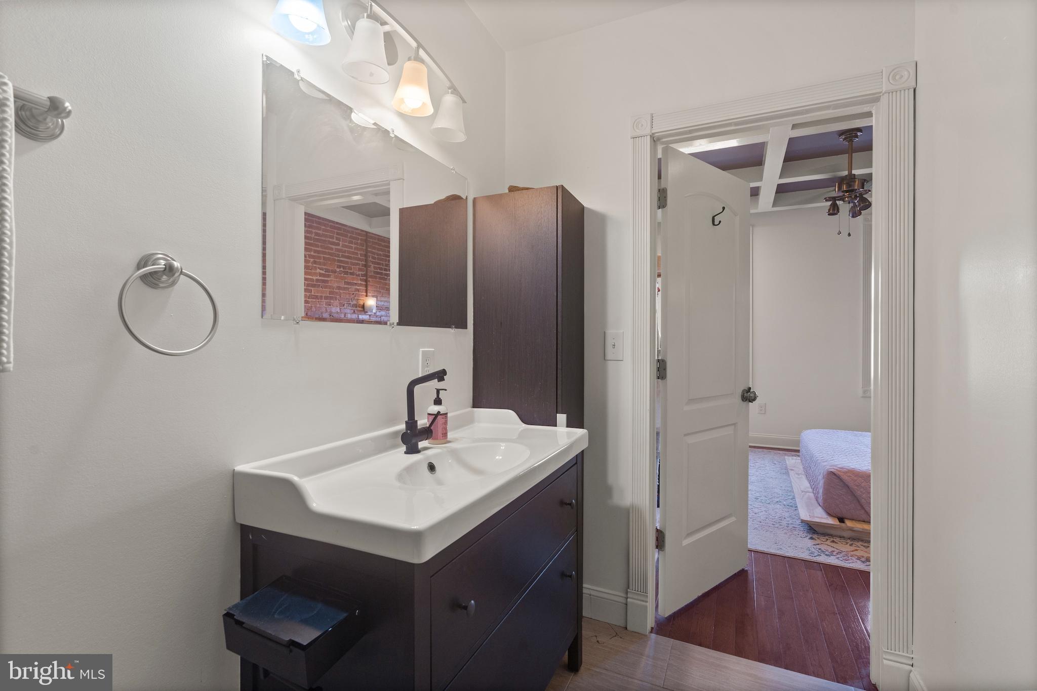 431 South Robinson Street Baltimore, MD 21224 - Photo 21 of 29 a bathroom with a sink a toilet and a mirror