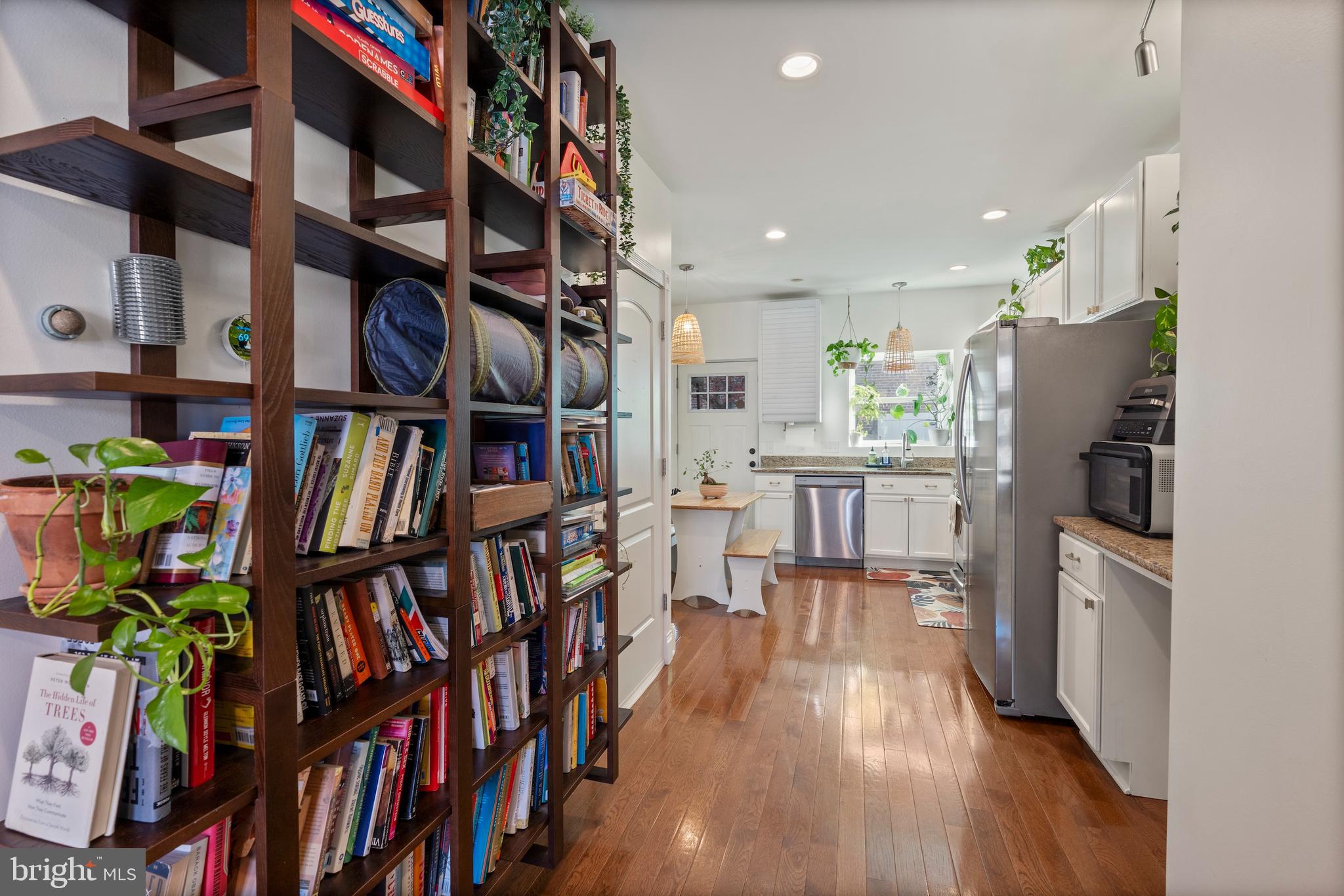 431 South Robinson Street Baltimore, MD 21224 - Photo 7 of 29 a living room with lots of furniture and a book shelf