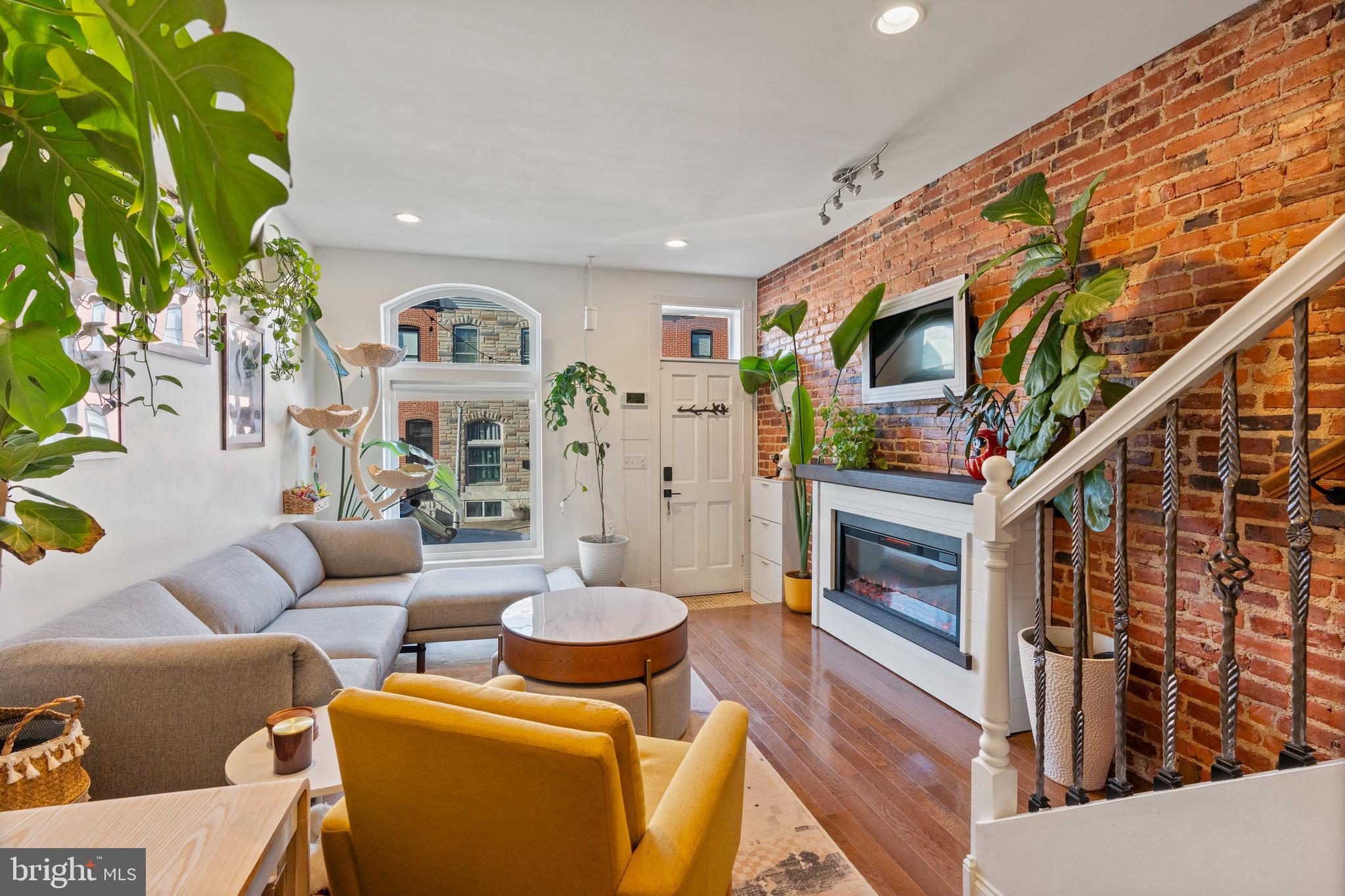431 South Robinson Street Baltimore, MD 21224 - Photo 8 of 29 a living room with furniture a flat screen tv and a fireplace