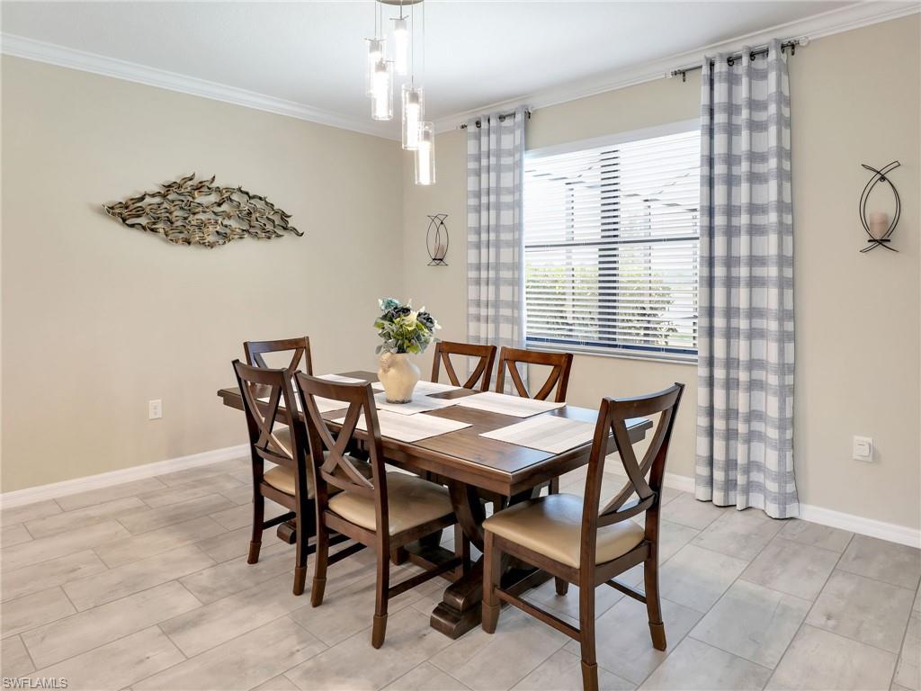 17528 Ashcomb Way Estero, FL 33928 - Photo 11 of 42 a view of a dining room with furniture and window