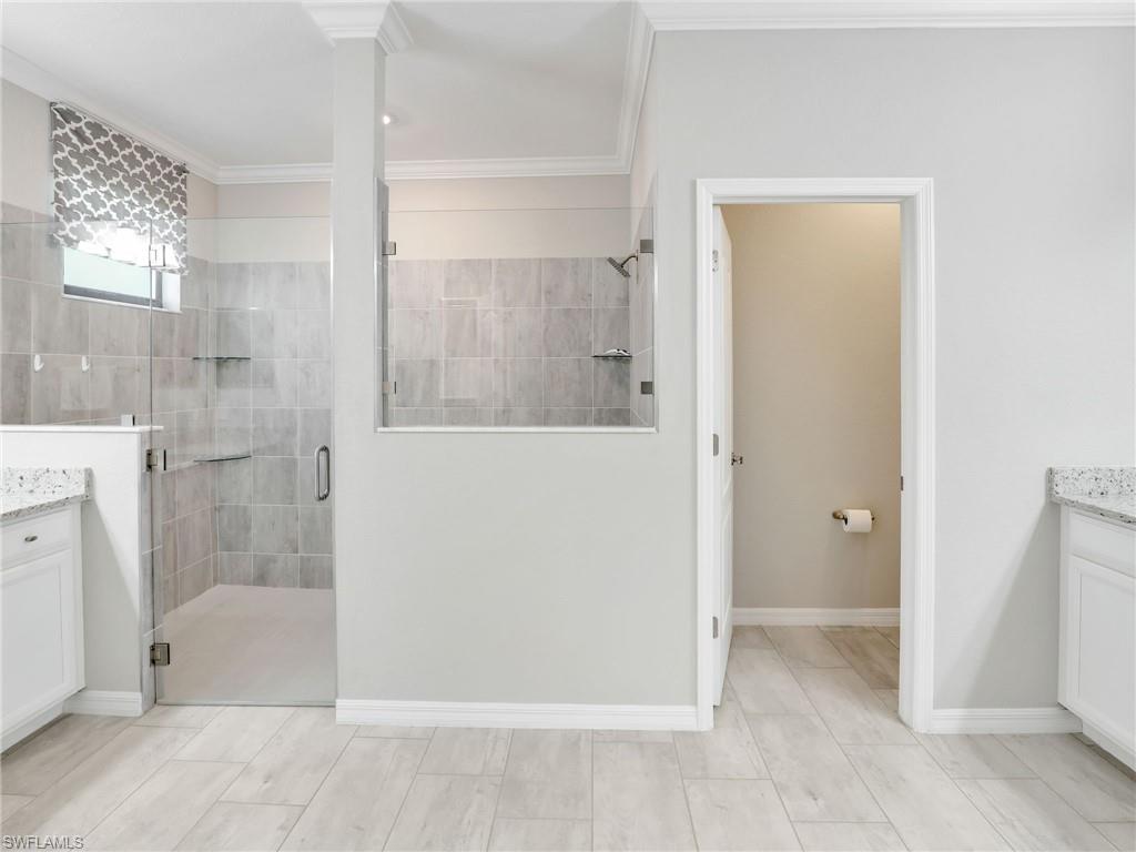 17528 Ashcomb Way Estero, FL 33928 - Photo 14 of 42 a bathroom with a bathtub and shower