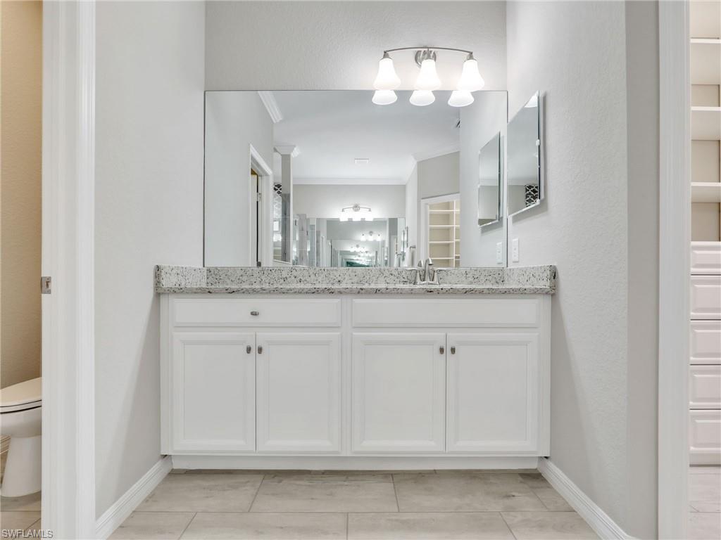 17528 Ashcomb Way Estero, FL 33928 - Photo 16 of 42 a bathroom with a sink and a mirror