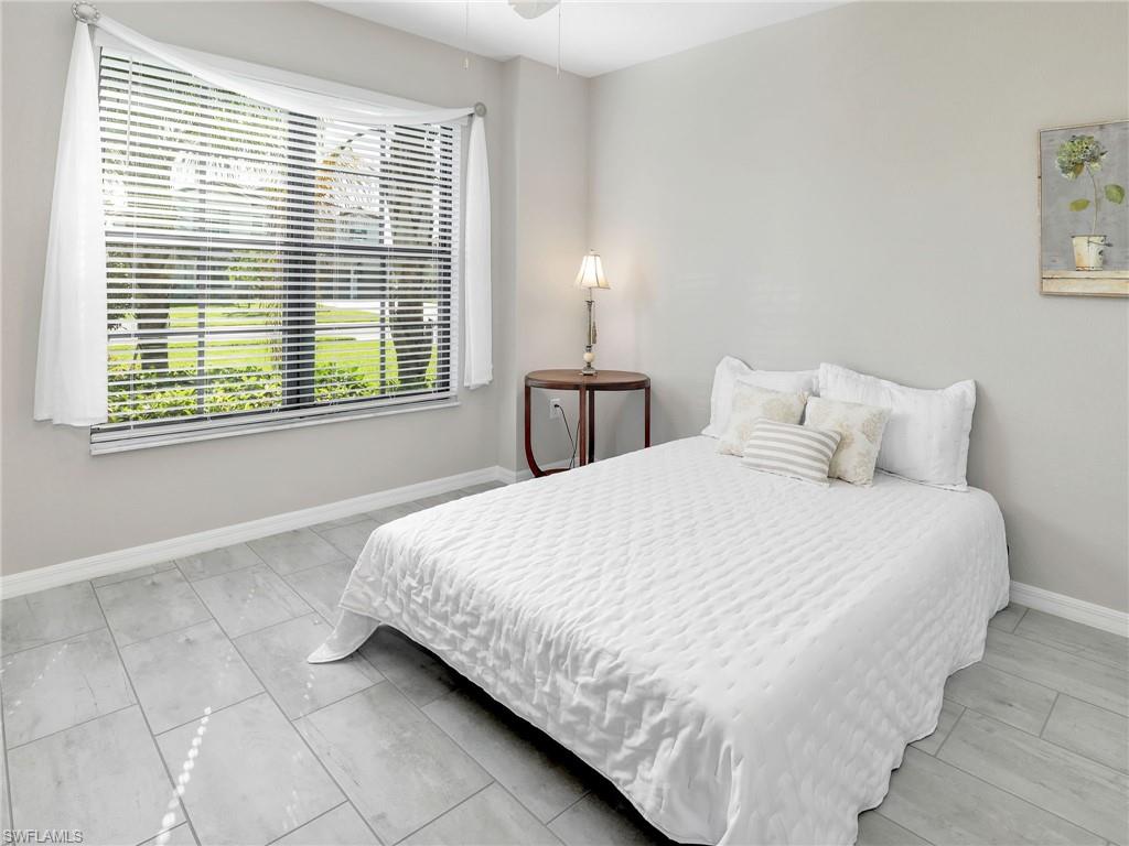 17528 Ashcomb Way Estero, FL 33928 - Photo 19 of 42 a bedroom with a bed and a window