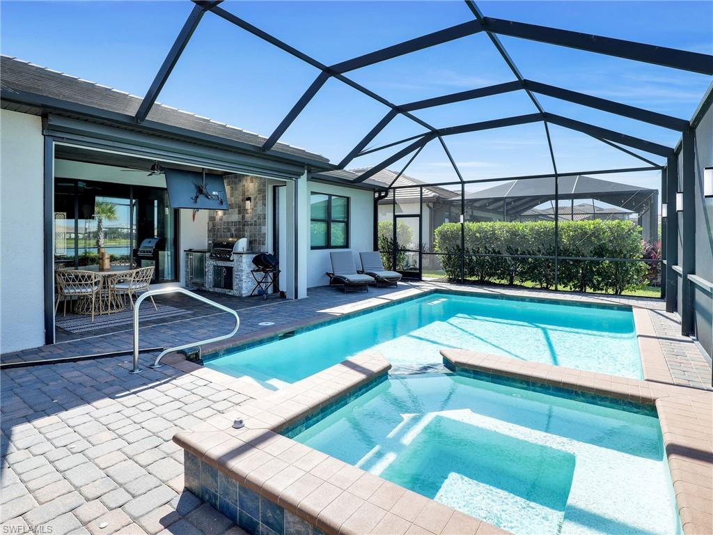 17528 Ashcomb Way Estero, FL 33928 - Photo 26 of 42 a view of a patio with table and chairs under an umbrella