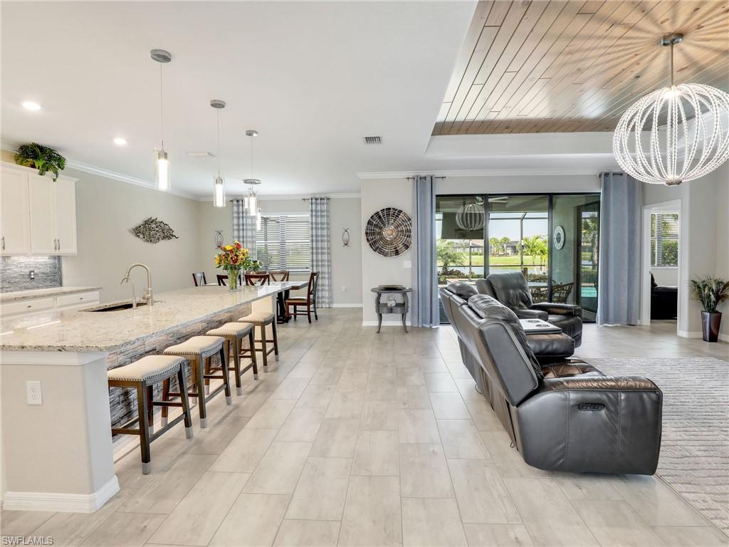 17528 Ashcomb Way Estero, FL 33928 - Photo 6 of 42 a large living room with stainless steel appliances furniture a chandelier open kitchen view