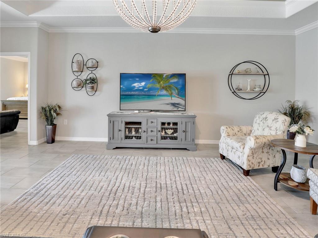 17528 Ashcomb Way Estero, FL 33928 - Photo 9 of 42 a living room with furniture and a flat screen tv
