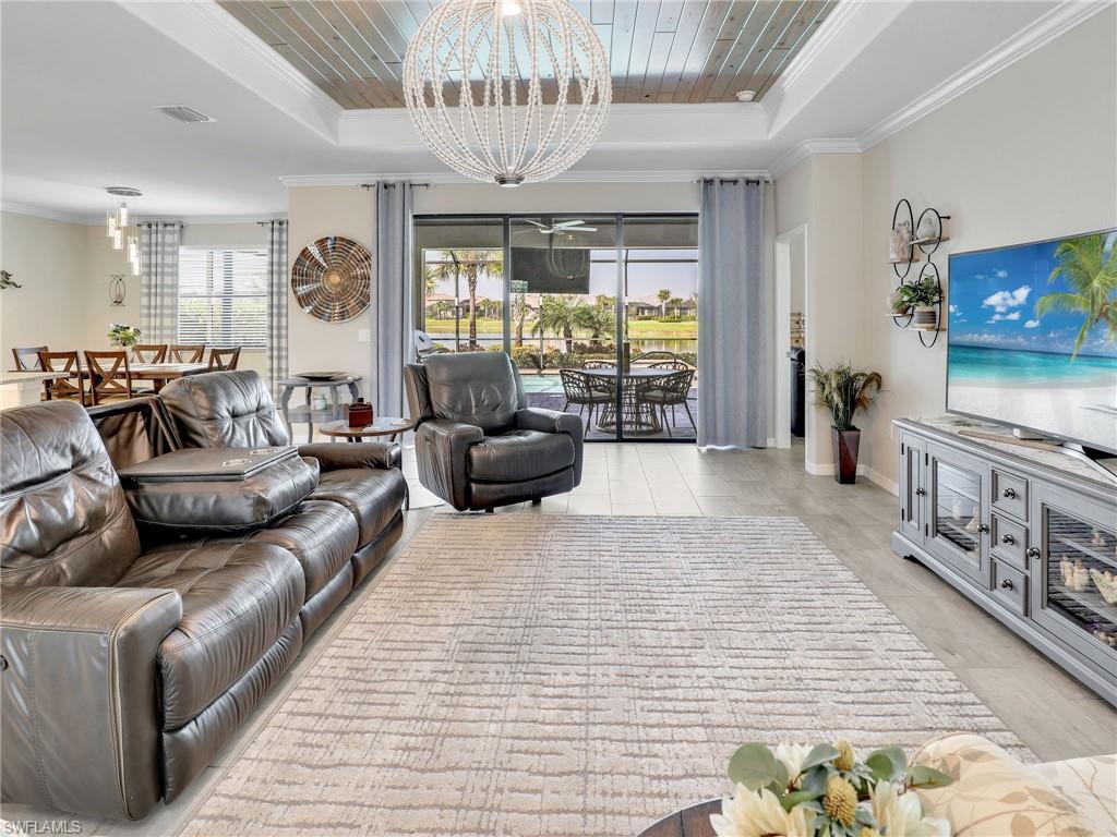 17528 Ashcomb Way Estero, FL 33928 - Photo 10 of 42 a living room with furniture and a flat screen tv
