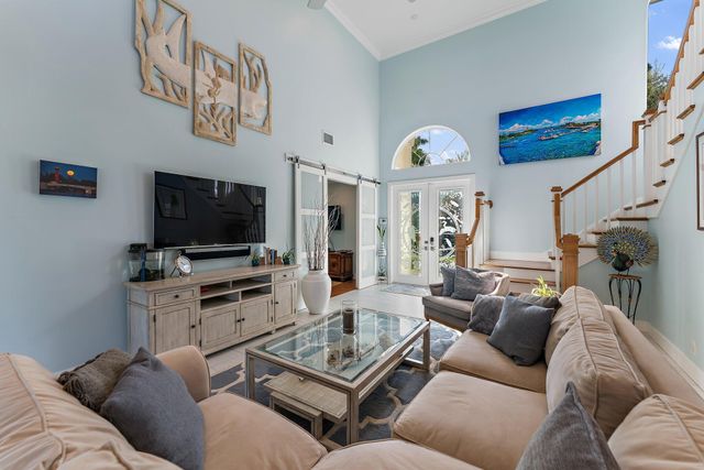a view of a dining room with furniture a rug and wooden floor