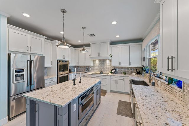 a kitchen with a sink cabinets and window