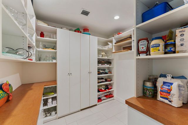 a living room with furniture pool table and a large window