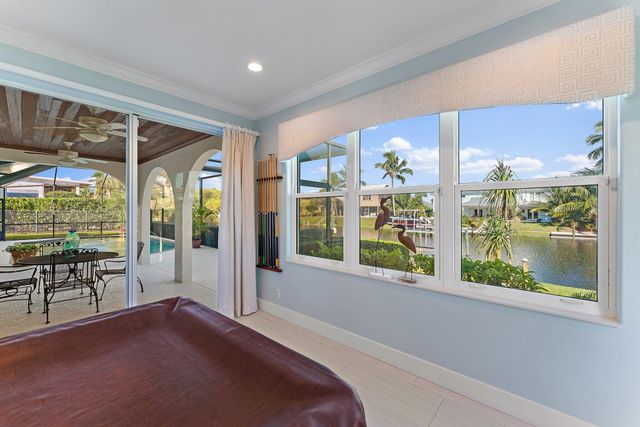 a bedroom with a bed and a flat tv screen on the dresser