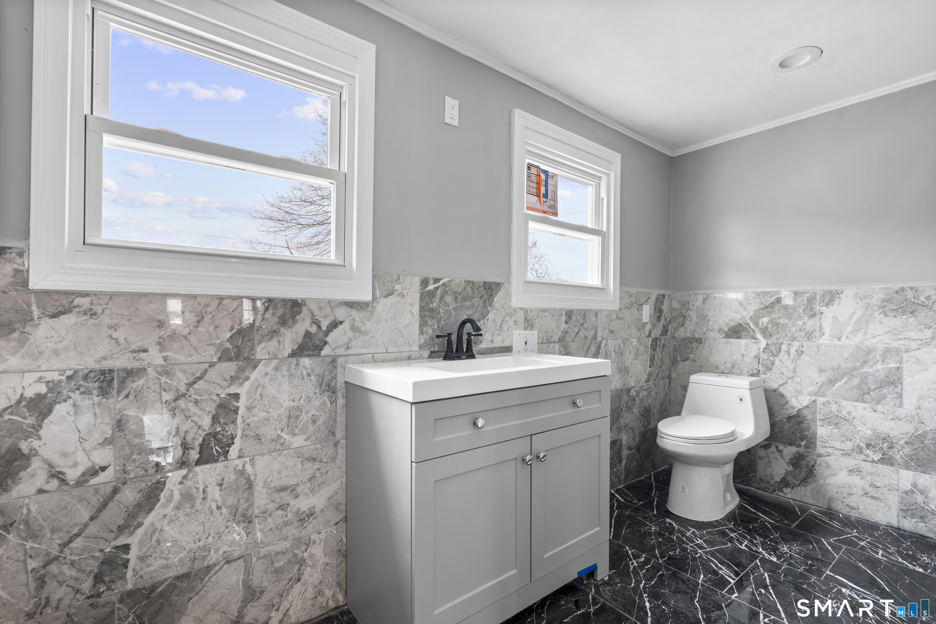 171 Foster Street Meriden, CT 06451 - Photo 11 of 35 a bathroom with a toilet sink and mirror