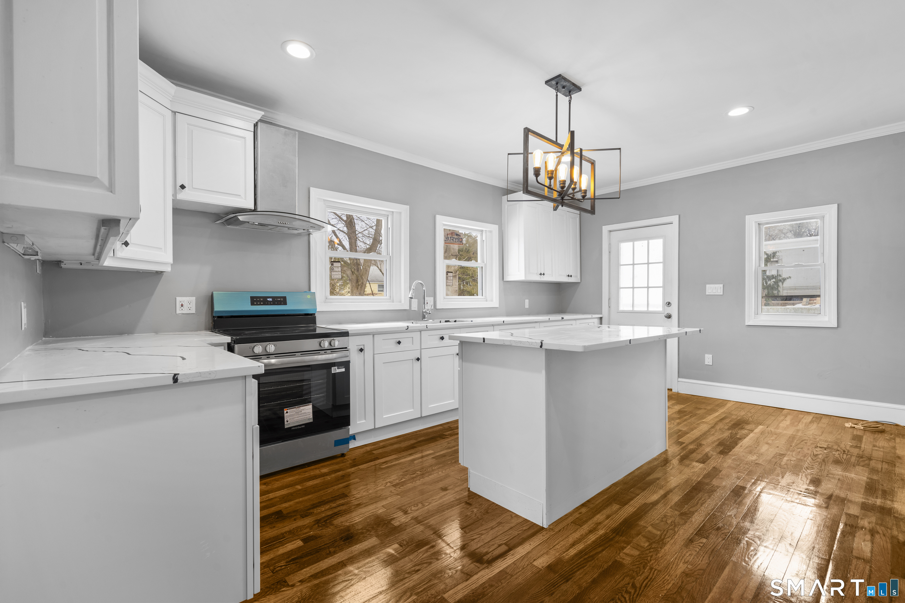171 Foster Street Meriden, CT 06451 - Photo 14 of 35 a kitchen with stainless steel appliances granite countertop a stove top oven a sink a refrigerator and white cabinets with wooden floor