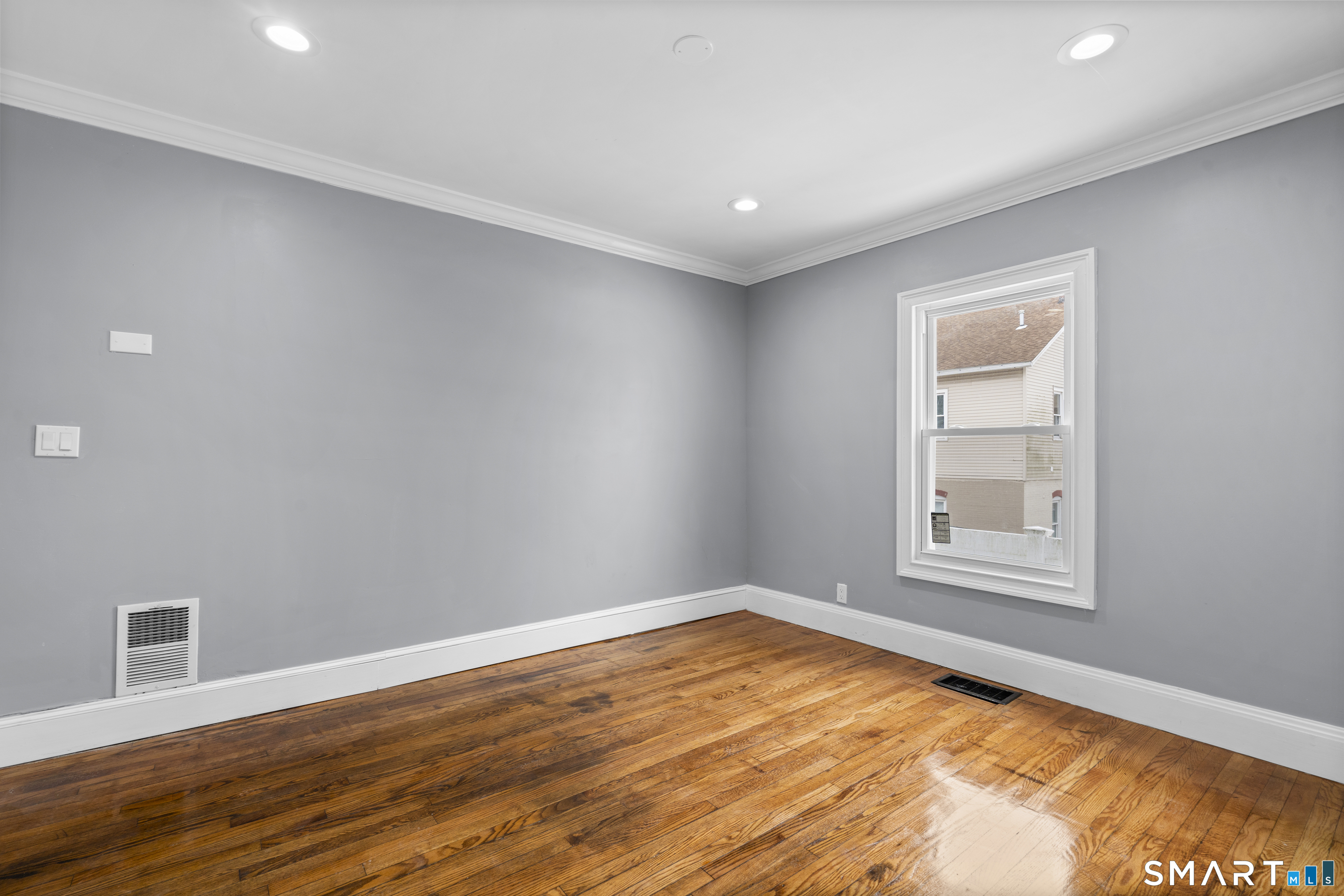 171 Foster Street Meriden, CT 06451 - Photo 16 of 35 a view of empty room with wooden floor and fan