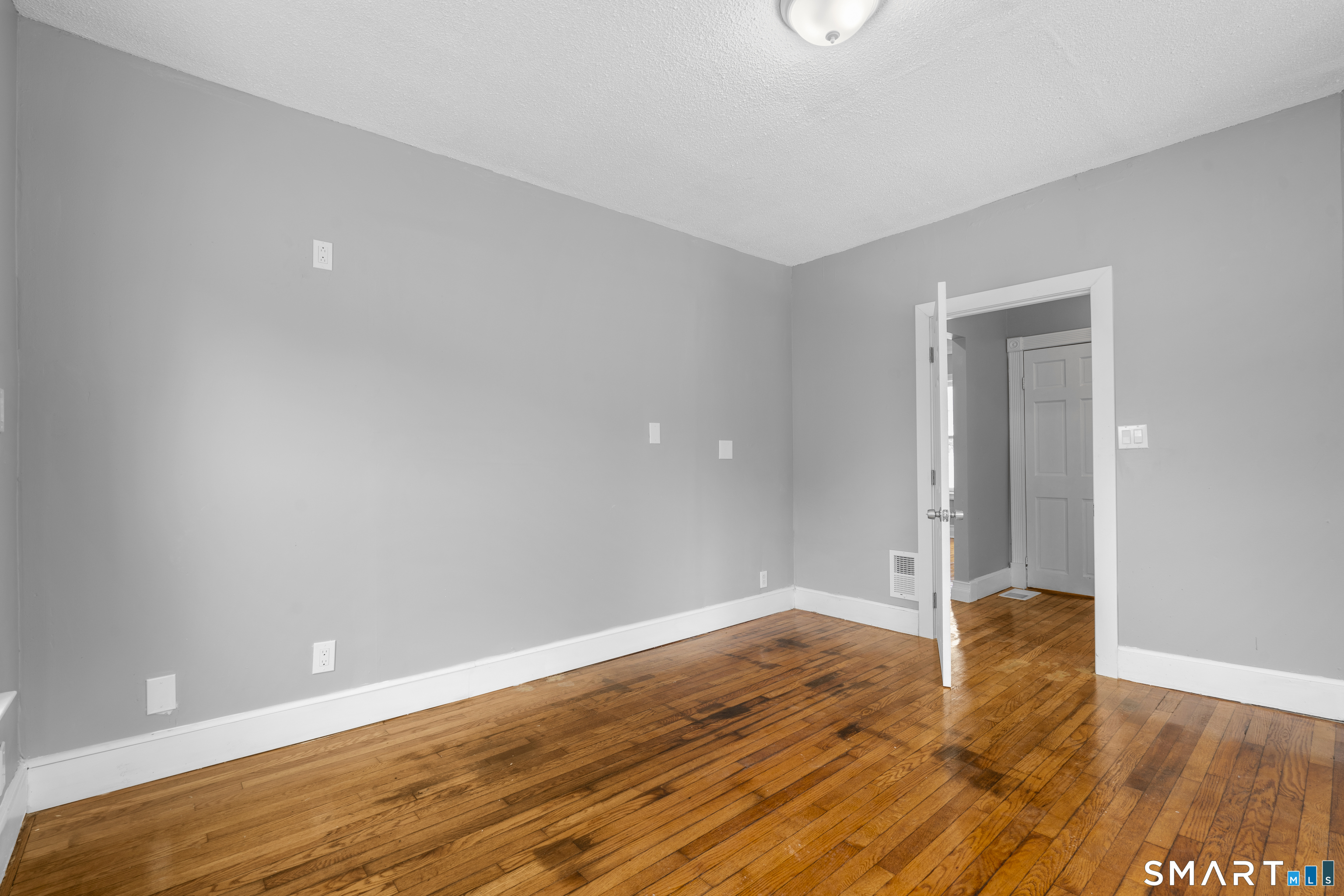 171 Foster Street Meriden, CT 06451 - Photo 4 of 35 a view of an empty room with wooden floor
