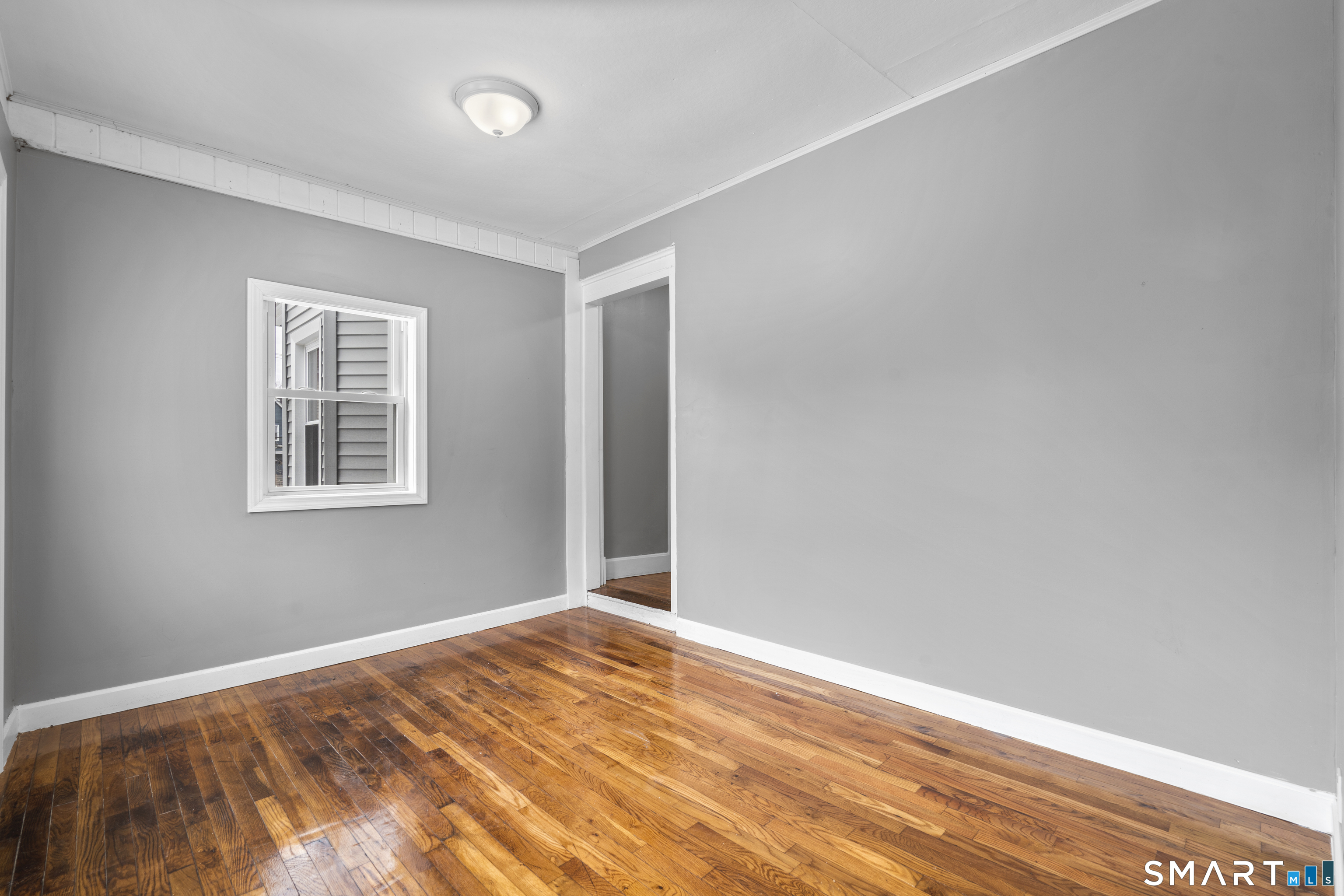171 Foster Street Meriden, CT 06451 - Photo 6 of 35 a view of empty room with wooden floor