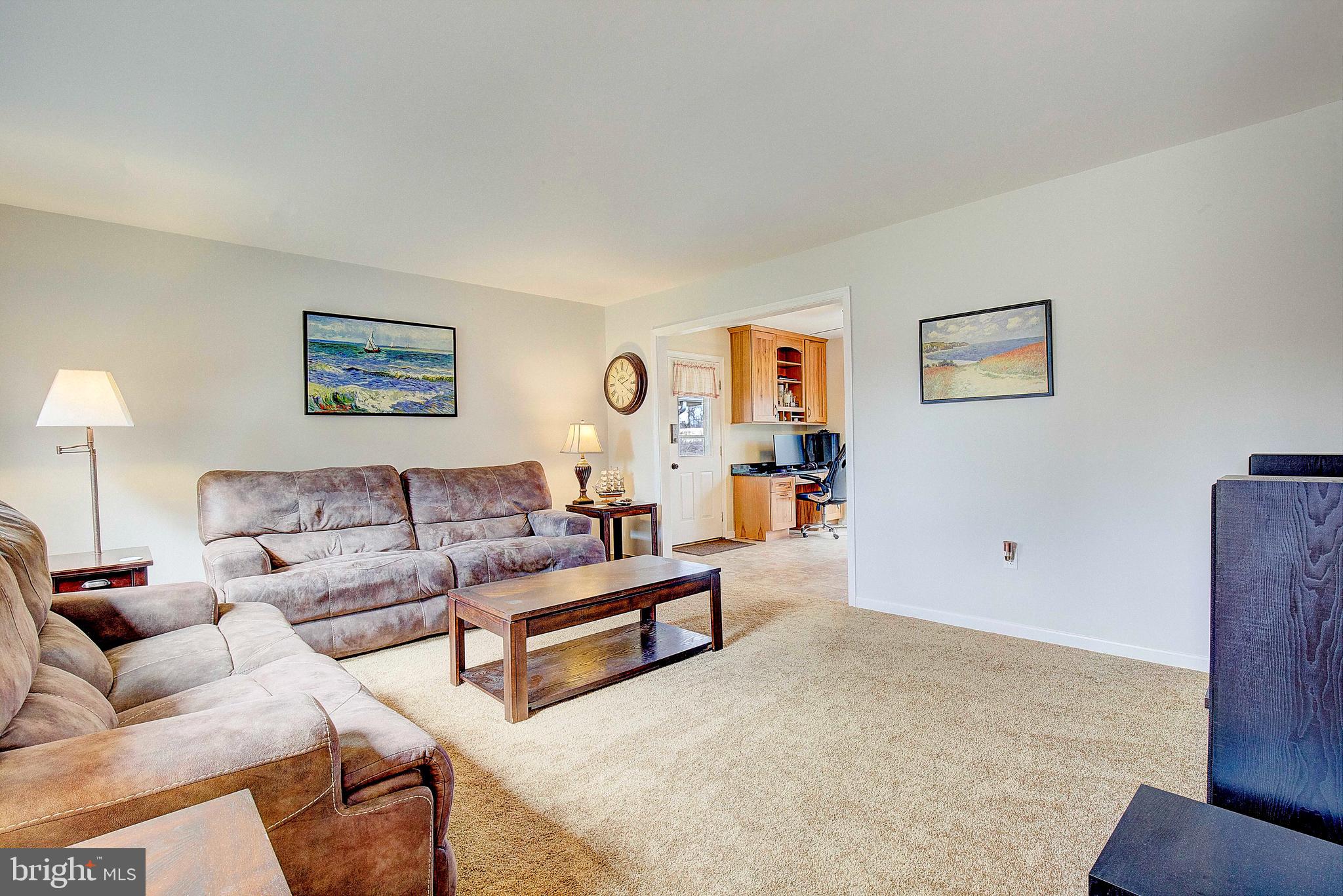 9150 Mackall Road St. Leonard, MD 20685 - Photo 8 of 48 a living room with furniture and a night stand