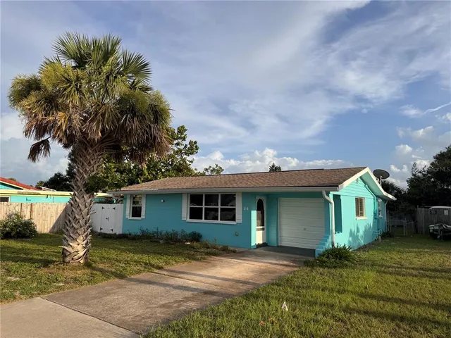 a front view of a house with a garden and yard
