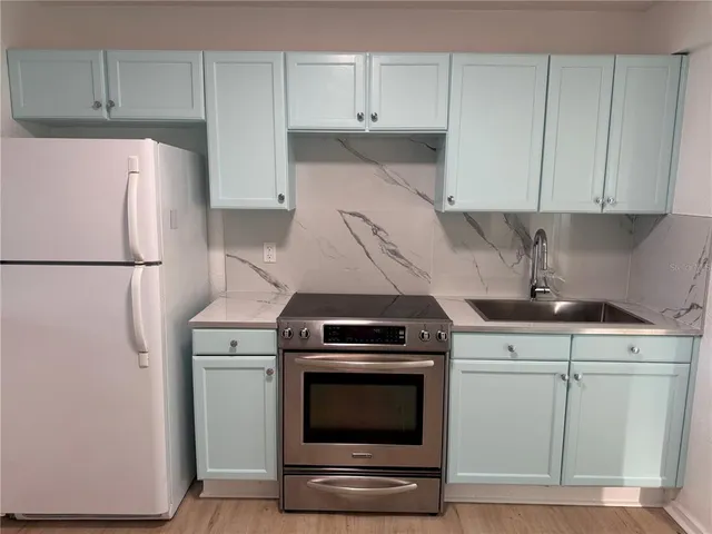 a kitchen with cabinets and steel stainless steel appliances