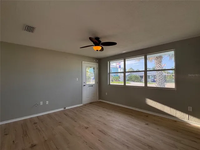 wooden floor in an empty room with a window