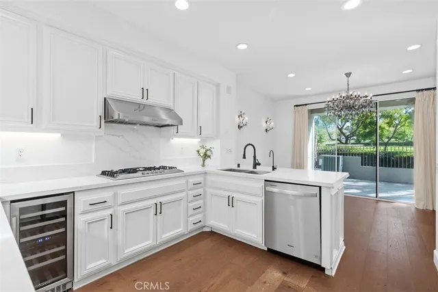 a kitchen with a sink stove and cabinets