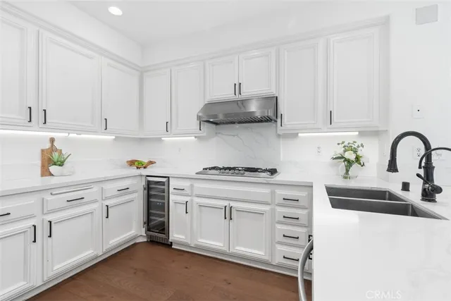 a kitchen with cabinets appliances and a sink