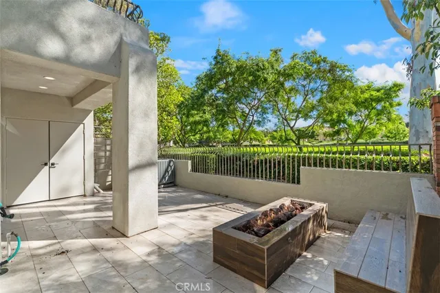 a balcony with wooden floor table and chairs
