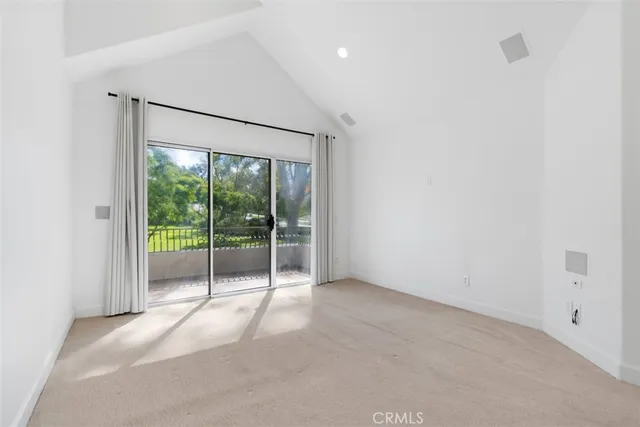 a view of an empty room with glass door