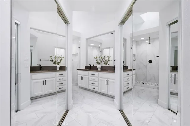 a spacious bathroom with a granite countertop sink mirror and shower