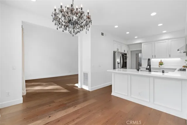 a kitchen with stainless steel appliances a refrigerator and a sink