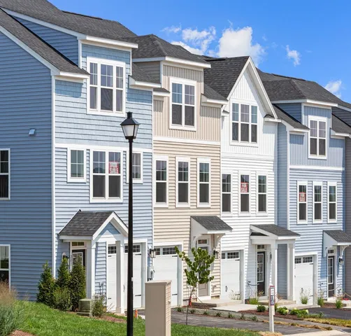 a front view of a residential apartment building with a yard