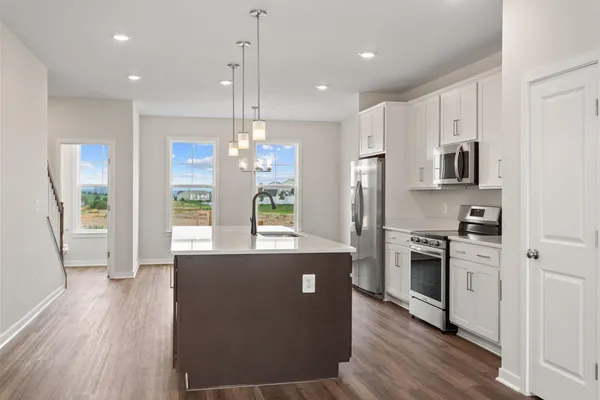 a living room with wooden floor and a sink