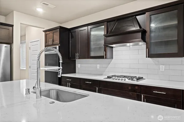 a kitchen with a sink and refrigerator