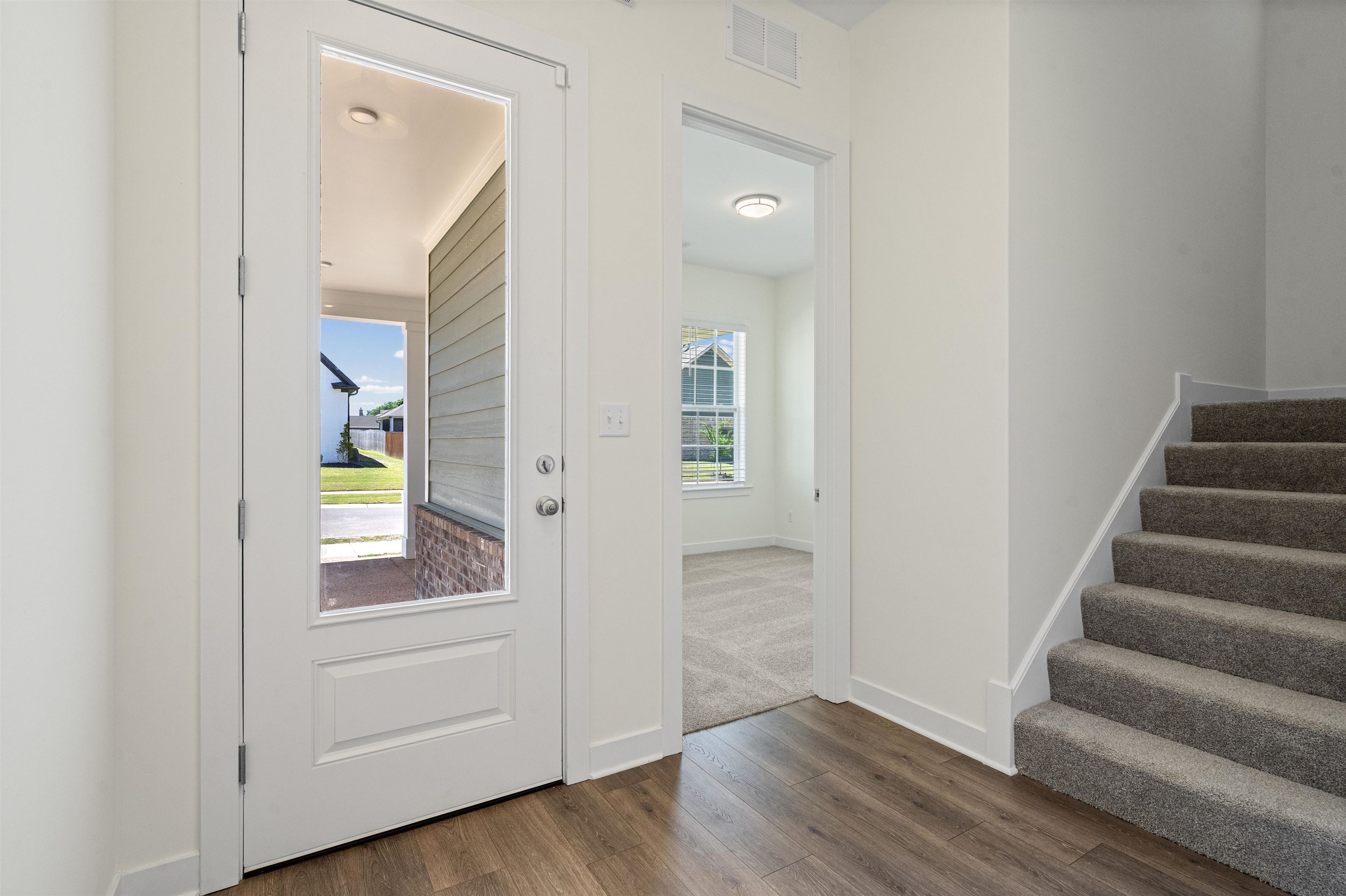 5666 Pleasant Pk Place Arlington, TN 38002 - Photo 4 of 27 Entry foyer featuring wood-finish flooring, a full-lite entry door, and a carpeted staircase
