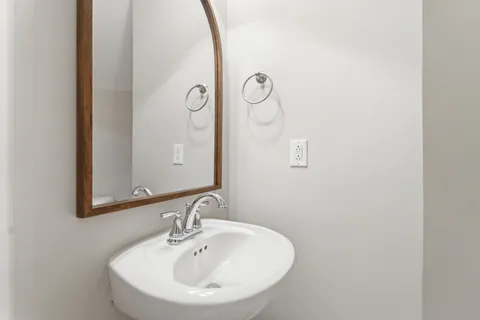 a bathroom with a sink and mirror