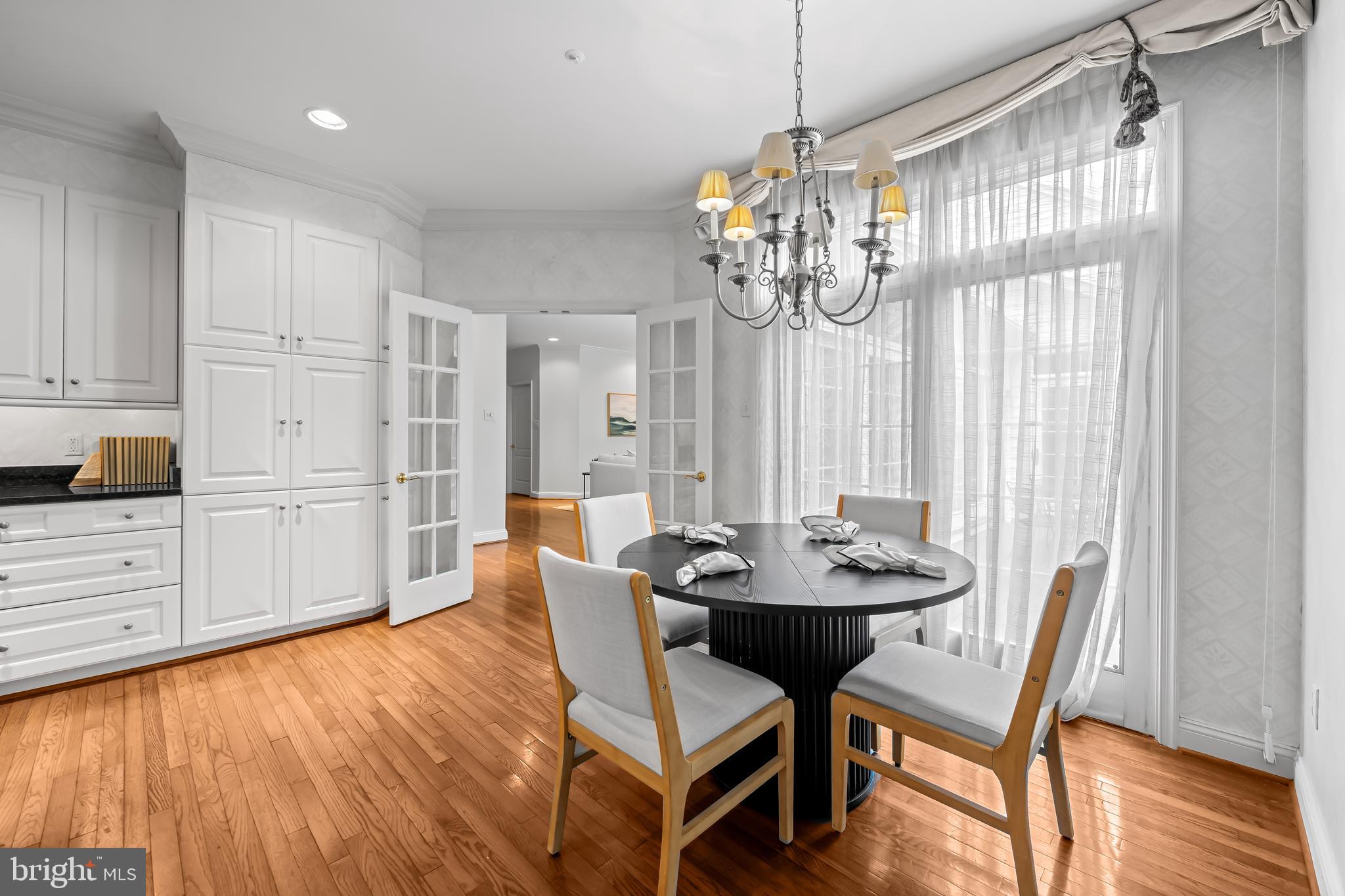 24 Roland Green, Unit 12 Baltimore, MD 21210 - Photo 12 of 53 a view of a dining room with furniture a chandelier and wooden floor