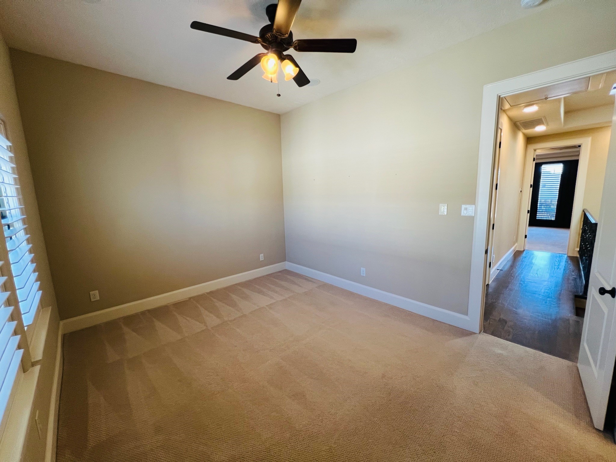 4310 Floyd Street, Unit B Houston, TX 77007 - Photo 35 of 44 an empty room with a chandelier fan and wooden floor