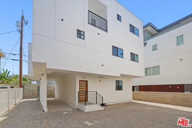 a view of a brick house with many windows