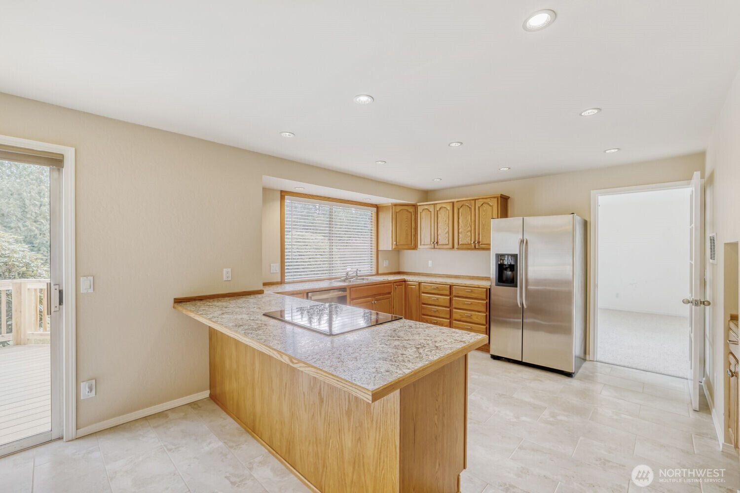20115 48th Avenue Southeast Bothell, WA 98012 - Photo 7 of 26 a kitchen with stainless steel appliances granite countertop a sink a refrigerator and a stove