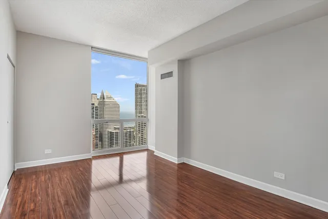 a view of wooden floor and windows in a room