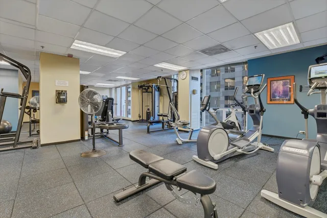a room with gym equipment and large mirror