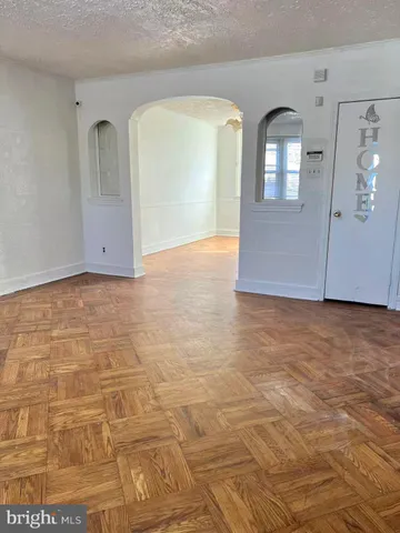 a view of a livingroom with wooden floor and a fireplace