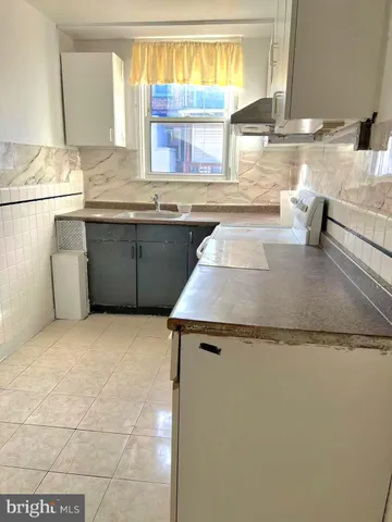 a kitchen with stainless steel appliances granite countertop a sink and a stove